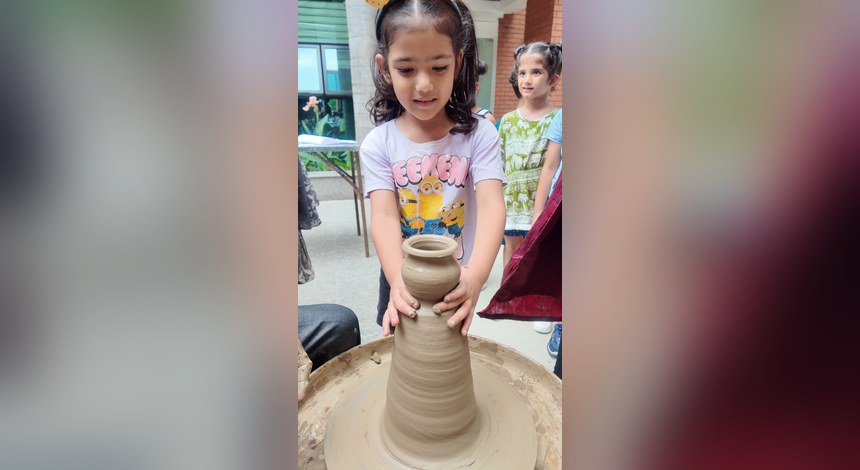 Mud Day: a potter’s wheel, and two hands learning what clay does at Birla Open Minds International School, Bhopal