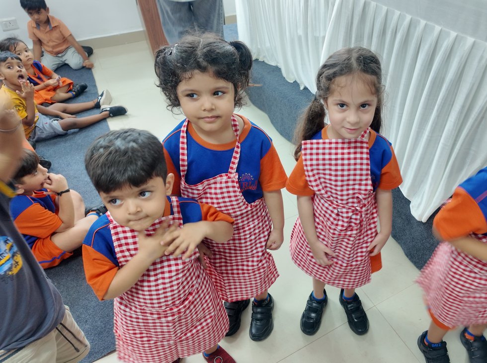 Chocolate Day, in the red-check pinafores of the early years at Birla Open Minds International School, Bhopal